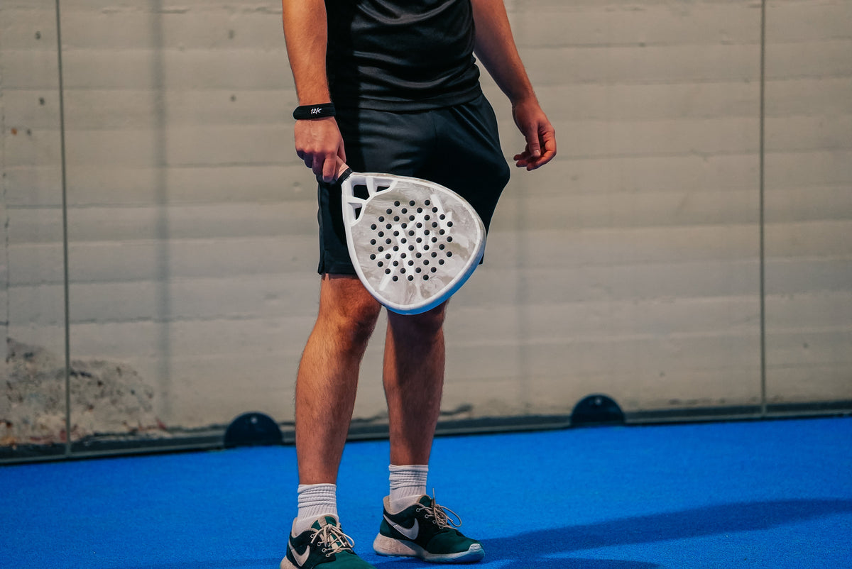 12K Padel racket on a blue padel court