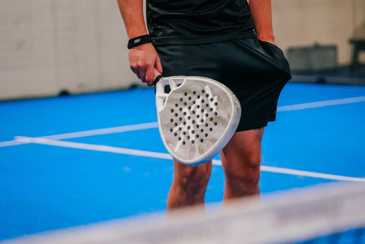 12K Padel racket on a blue padel court