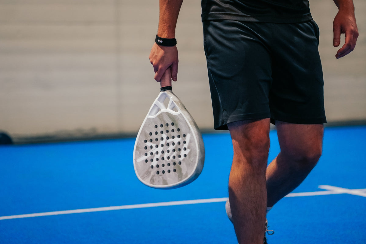 12K Padel racket on a blue padel court