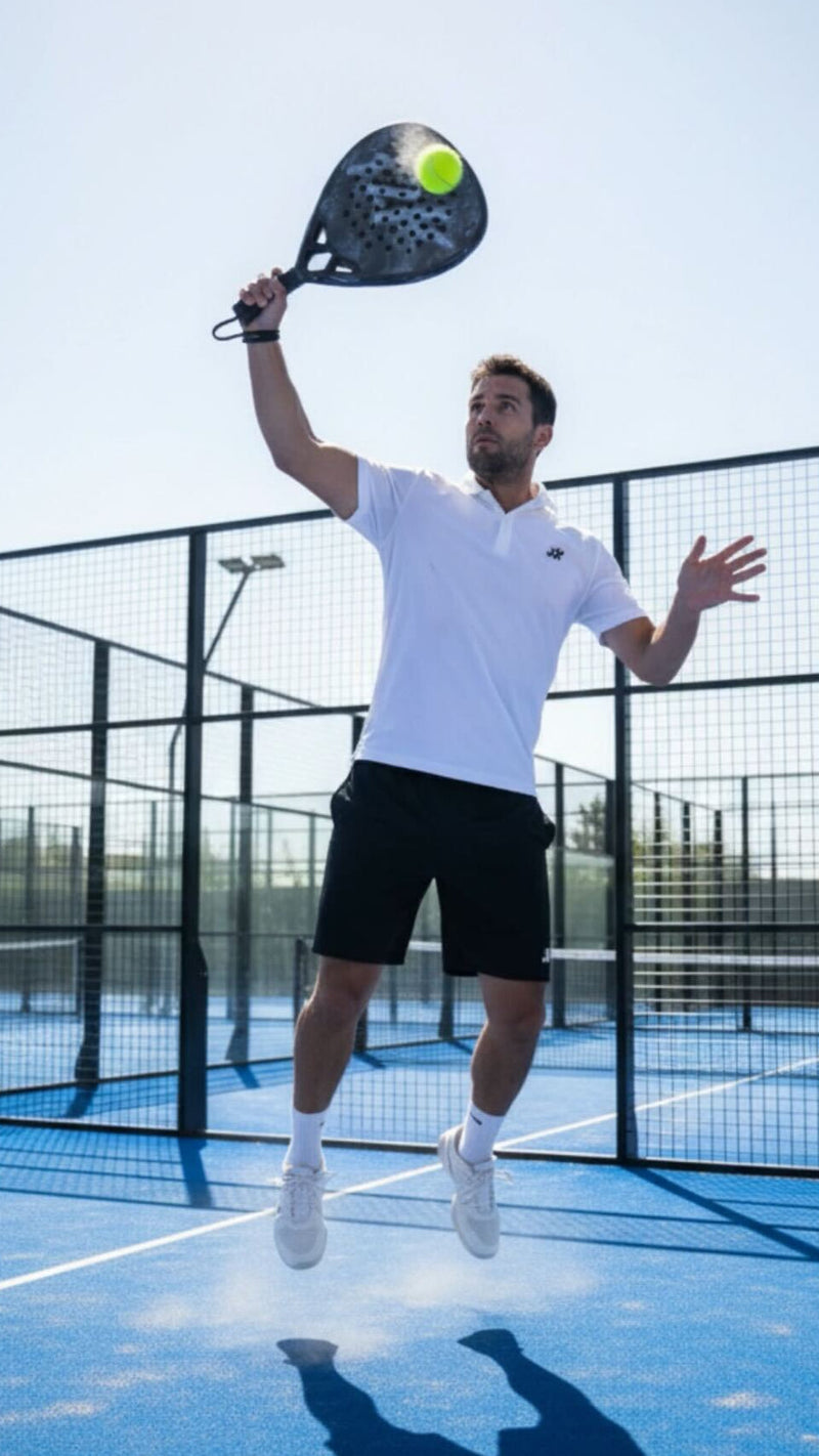 A padel racket resting on a padel court