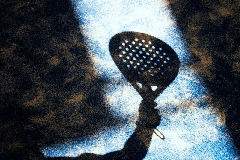 Padel player preparing to strike the ball on an outdoor court