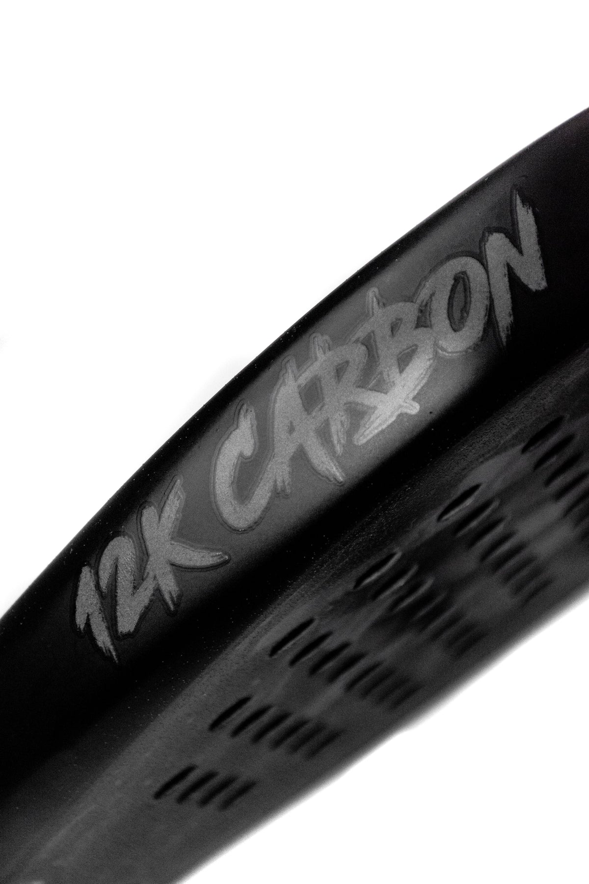 Close up of the 12K Carbon branding on the edge guard of a 12K Padel Midnight Black racket