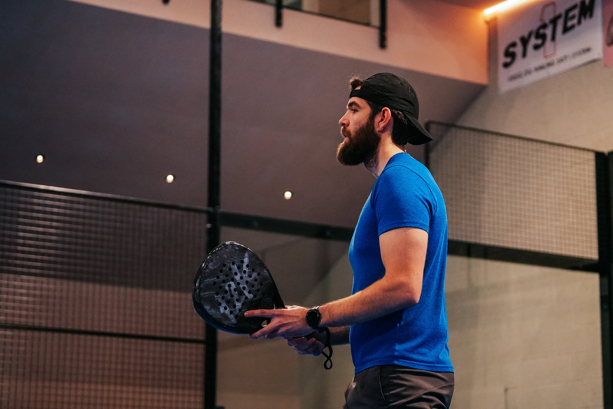 Padel player using the walls on court with a 12K Padel racket