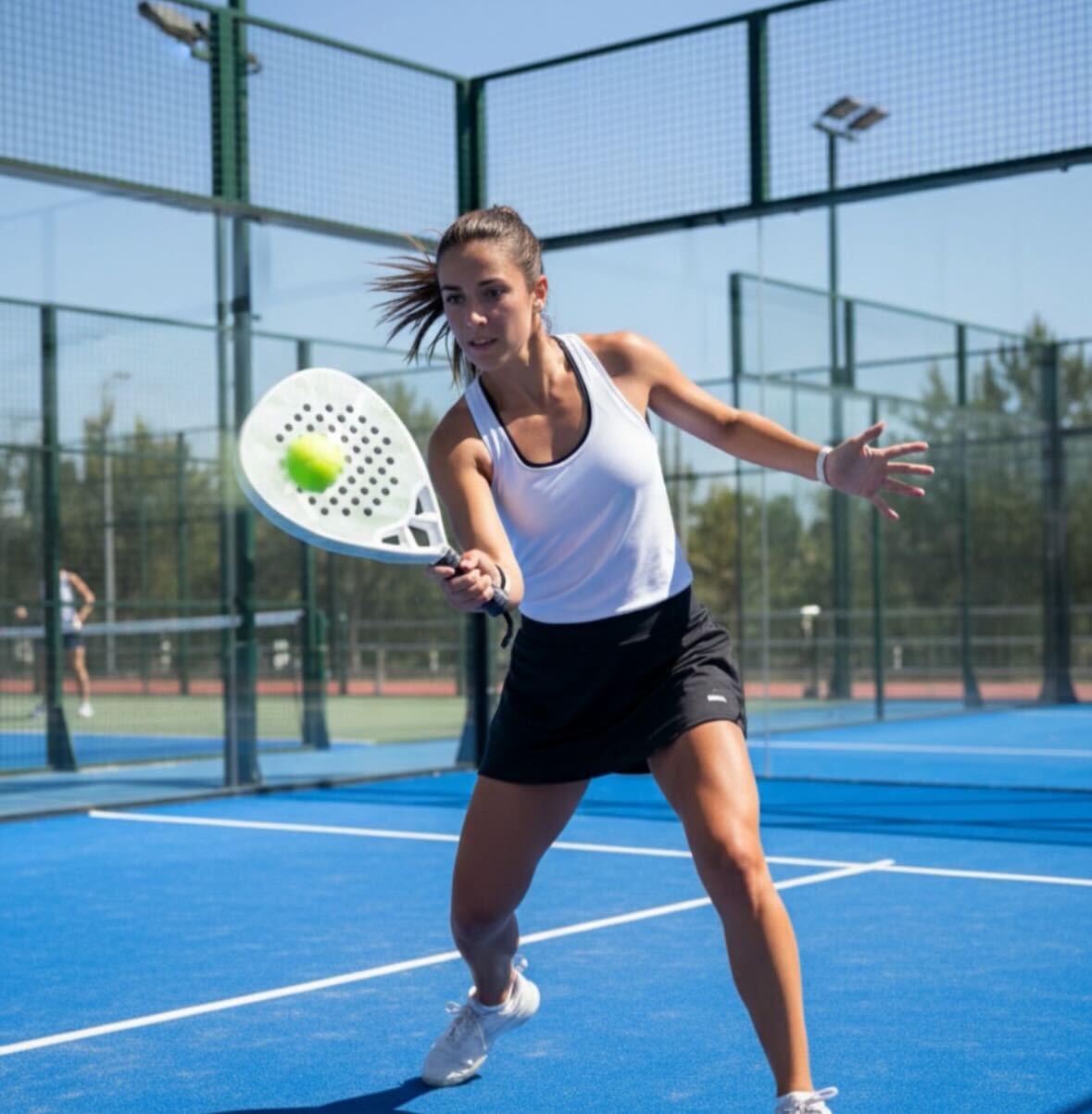 Padel player taking a break on court after a match