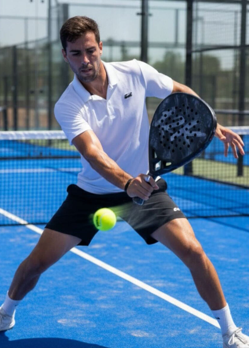 Padel racket and ball resting on a padel court, comparing padel to pickleball