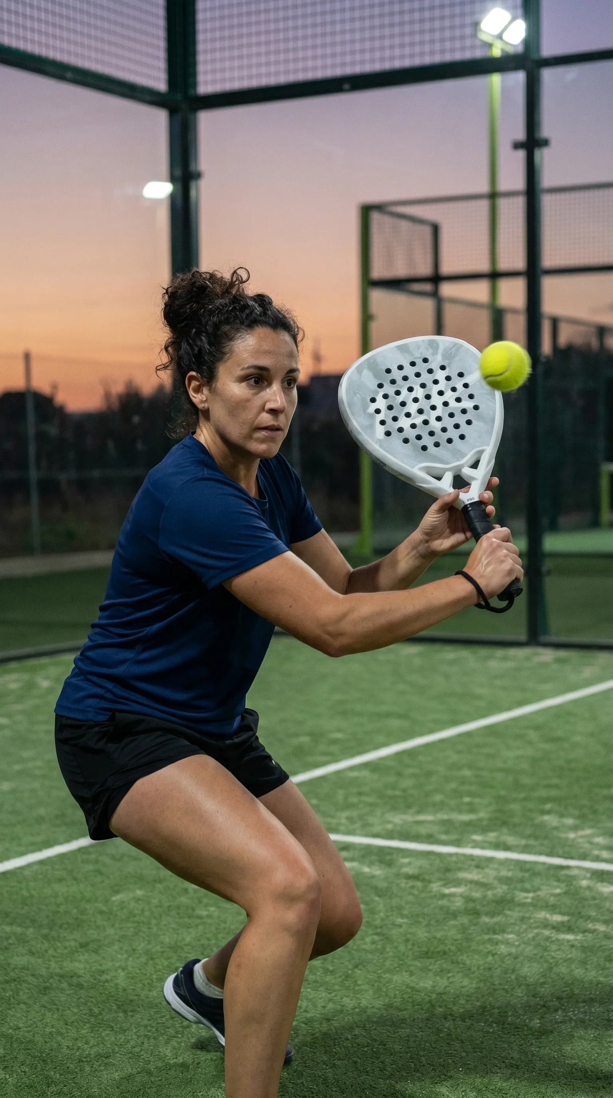 12K Padel Ice White racket, player at sunset on an outdoor court