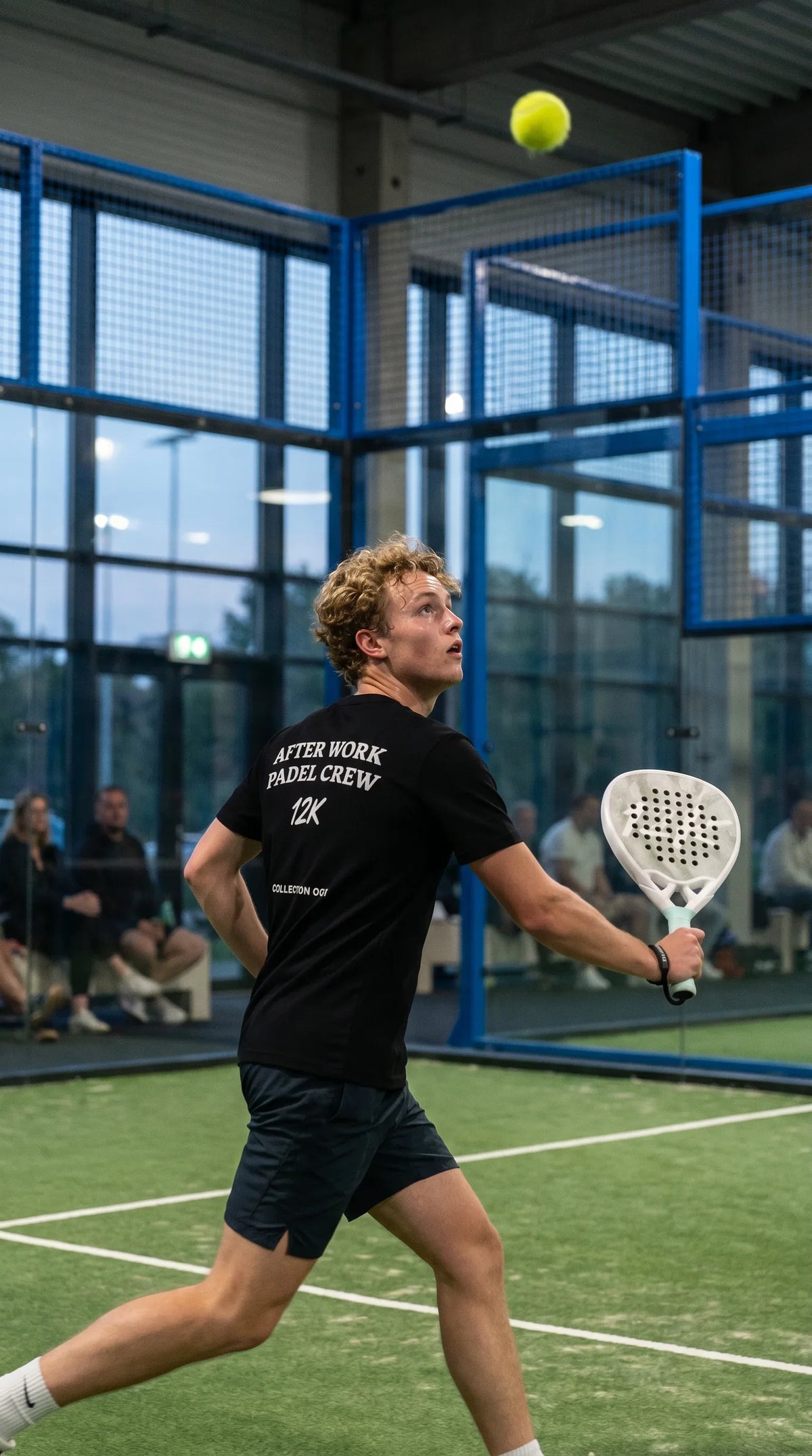12K Padel Ice White racket, player running to the net in the After Work Padel Crew tee