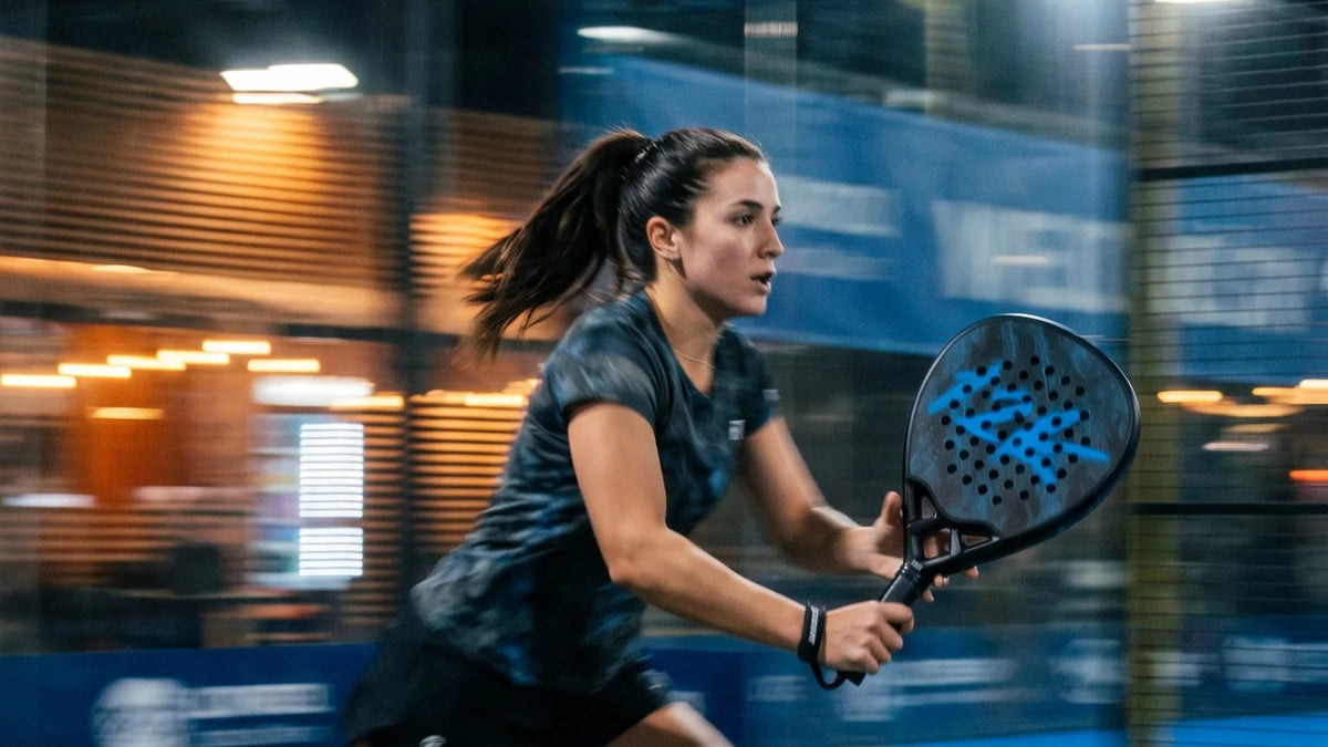 12K Padel Shark Blue racket, player on the move on an indoor court