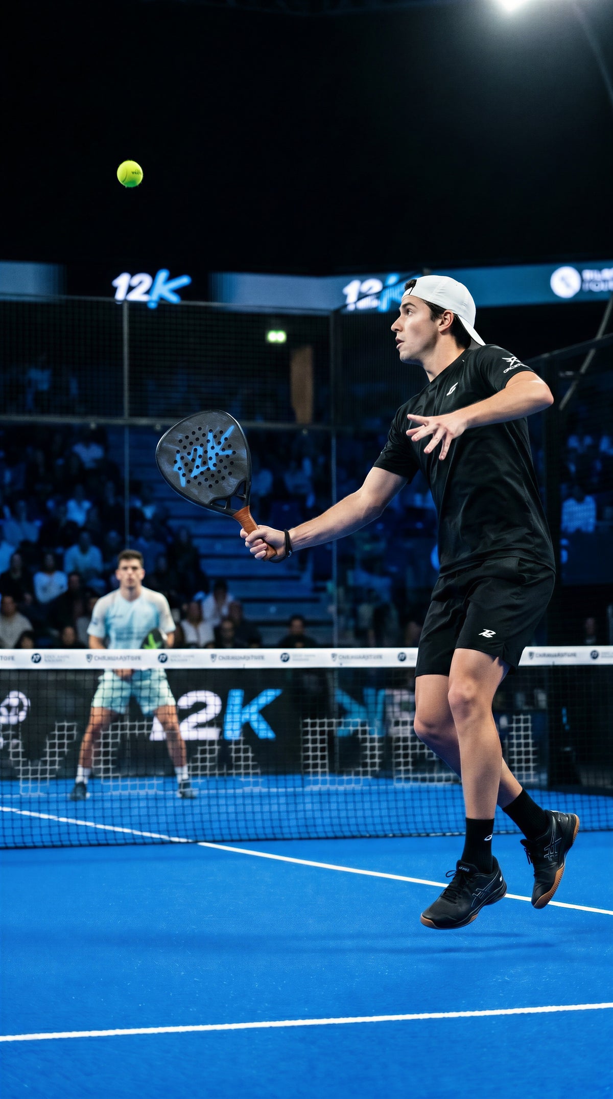 12K Padel Shark Blue racket, player serving on the 12K branded court